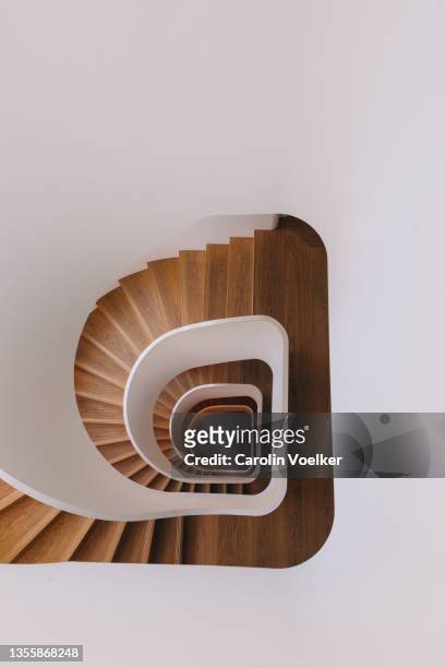 top view of modern wooden spiral stairs - wide stock-fotos und bilder