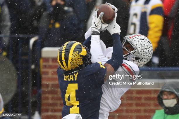 Garrett Wilson of the Ohio State Buckeyes catches a touchdown pass over Vincent Gray of the Michigan Wolverines during the second quarter at Michigan...