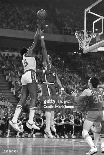 Denver Nuggets forward Paul Silas shoots a floating layup over Portland Trail Blazers forward Maurice Lucas during an NBA playoff game at McNichols...