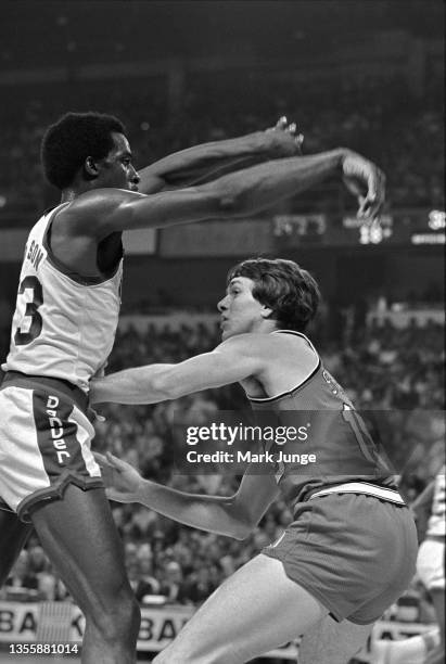 Denver Nuggets forward David Thompson passes the basketball over Portland Trail Blazers guard Larry Steele during an NBA playoff game at McNichols...