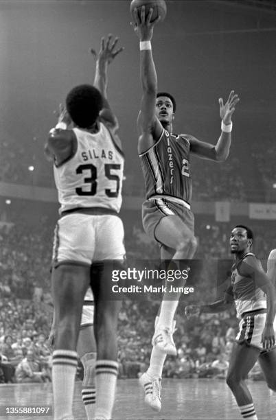 Portland Trail Blazers forward Maurice Lucas lays the basketball over Denver Nuggets forward Paul Silas during an NBA playoff game at McNichols Arena...