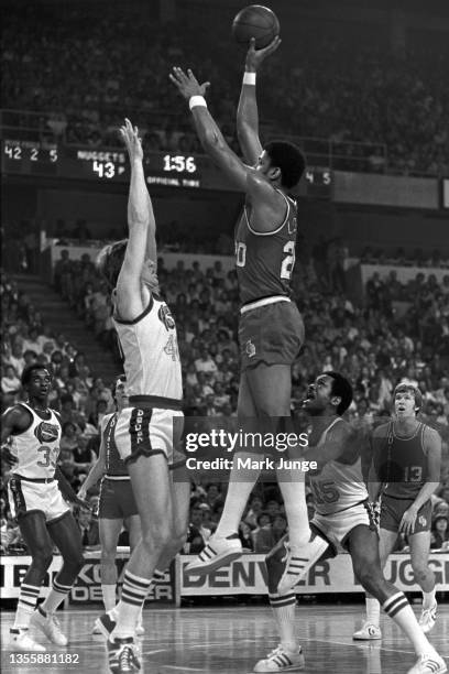 Portland Trail Blazers forward Maurice Lucas, shoots a floater over Denver Nuggets forward Byron Beck during an NBA playoff game at McNichols Arena...