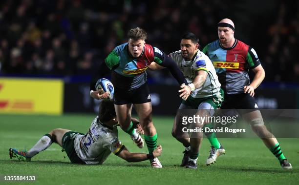 Huw Jones of Harlequins is tackled by Bernard Janse van Rensburg and Curtis Rona during the Gallagher Premiership Rugby match between Harlequins and...