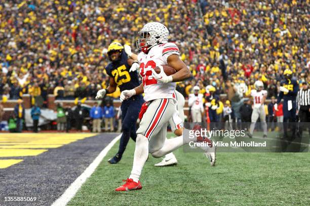 TreVeyon Henderson of the Ohio State Buckeyes carries the ball for a touchdown in the second half of the game against the Michigan Wolverines at...