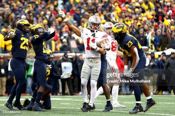 Jaxon Smith-Njigba of the Ohio State Buckeyes reacts after a first down pass in the second half of the game against the Michigan Wolverines at...