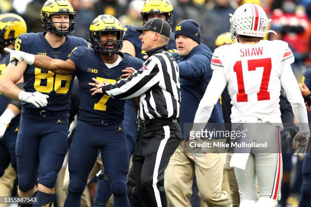 Donovan Edwards of the Michigan Wolverines argues with Bryson Shaw of the Ohio State Buckeyes in the third quarter of the game at Michigan Stadium on...