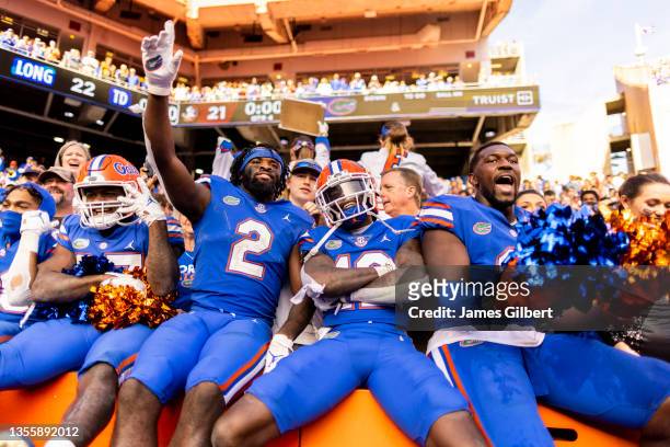 Kemore Gamble, Rick Wells, and Zachary Carter of the Florida Gators celebrate after defeating the Florida State Seminoles 24-21 in a game at Ben Hill...