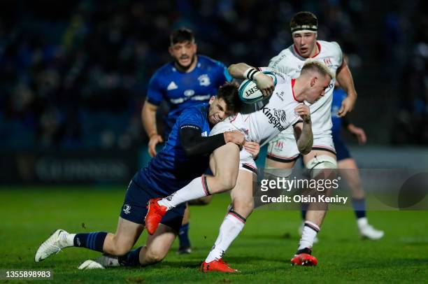 Craig Gilroy of Ulster is tackled by Harry Byrne of Leinster during the match between Leinster v Ulster at RDS Arena on November 27, 2021 in Dublin,...