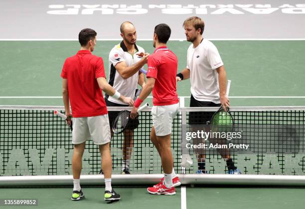 Novak Djokovic and Nikola Cacic of Serbia and Kevin Krawietz and Tim Puetz of Germany shake hands following the Davis Cup match between Novak...