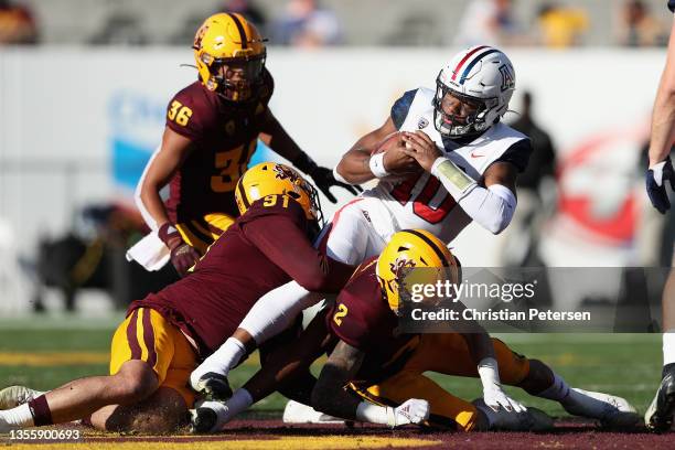 Wide receiver Jamarye Joiner of the Arizona Wildcats is tackled by defensive end Michael Matus of the Arizona State Sun Devils after a reception...