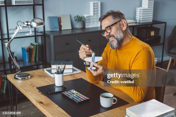 business man making plane model - middle aged man hobby stock pictures, royalty-free photos & images