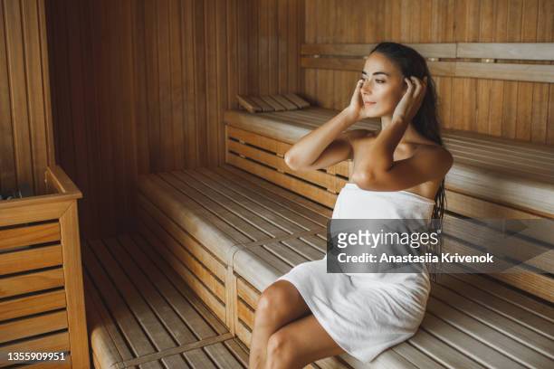 young beautiful slim woman relaxing in spa. - sauna stock-fotos und bilder