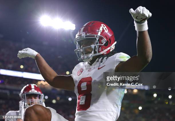 John Metchie III of the Alabama Crimson Tide reacts after scoring in the fourth overtime to defeat that Auburn Tigers 24-22 at Jordan-Hare Stadium on...