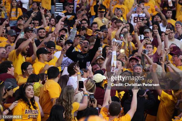Defensive back Chase Lucas of the Arizona State Sun Devils celebrates with the Territorial Cup after defeating the Arizona Wildcats at Sun Devil...