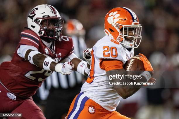 Running back Kobe Pace of the Clemson Tigers runs for a touchdown while pursued by defensive back David Spaulding of the South Carolina Gamecocks in...