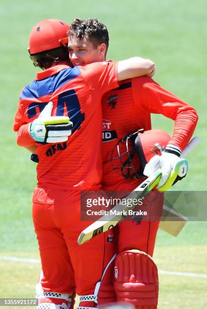 Alex Carey of the Redbacks celebrates bringing up his century with his captain Travis Head of the Redbacks during the Marsh One Day Cup match between...