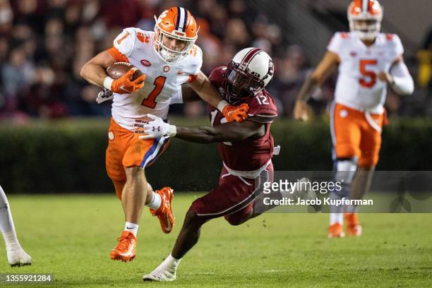 Defensive back Jaylan Foster of the South Carolina Gamecocks tries to tackle running back Will Shipley of the Clemson Tigers in the second quarter...