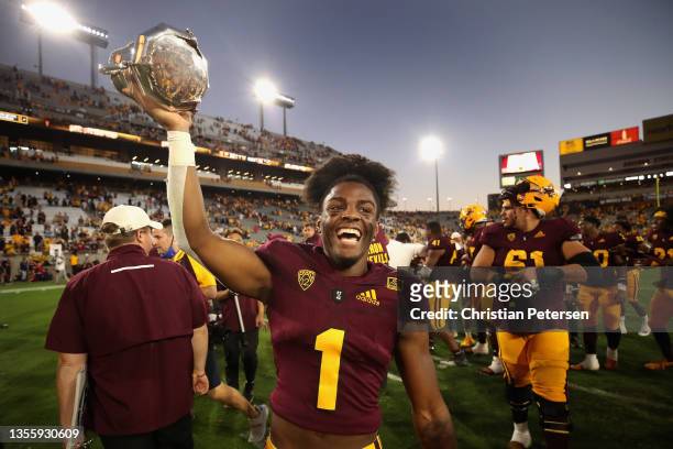 Defensive back Jordan Clark of the Arizona State Sun Devils celebrates with the Territorial Cup after defeating the Arizona Wildcats at Sun Devil...