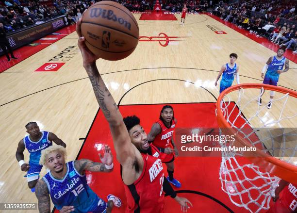 Christian Wood of the Houston Rockets dunks the ball during the first half ahead of Kelly Oubre Jr. #12 of the Charlotte Hornets at Toyota Center on...