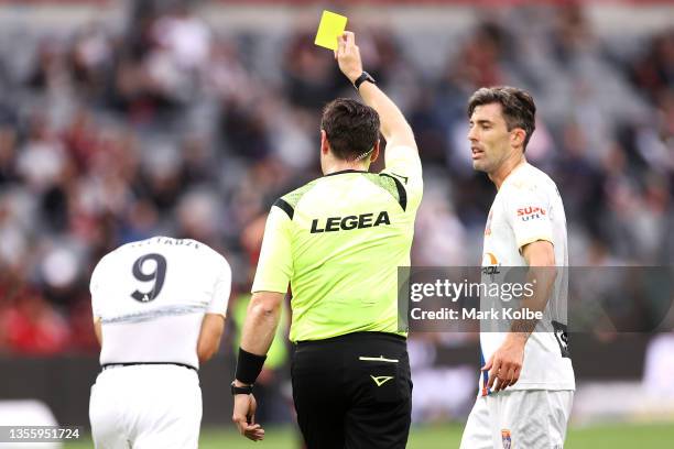 The referee shows Beka Mikeltadze of the Jets a yellow card for his celebration after scoring a goal during the A-League match between Western Sydney...