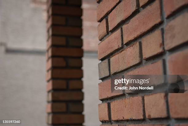 bricks covering wall and support column of small building - brick column stock pictures, royalty-free photos & images