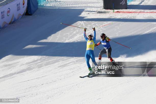Sergey Ridzik of Russia celebrates victory after crossing the finish line ahead of Brady Leman of Canada in the men's ski cross during the FIS Ski...