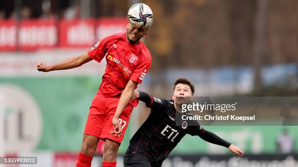 Louis Samson of Halle and Benjamin Hemcke of Viktoria Koeln go up for a header during the 3. Liga match between Viktoria Köln and Hallescher FC at...