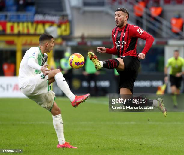 Theo Hernandez of AC Milan and Mert Muelduer of US Sassuolo battle for possession during the Serie A match between AC Milan and US Sassuolo at Stadio...