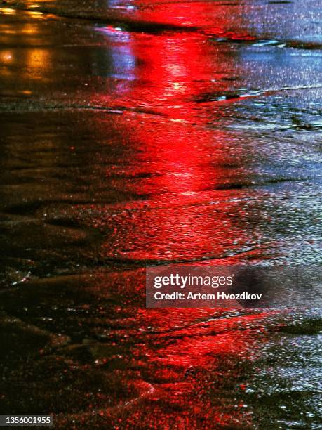 red light reflection on the wet asphalt from traffic light - red light stock pictures, royalty-free photos & images