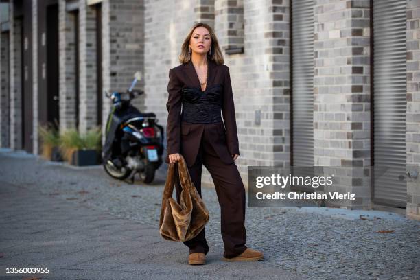 Amelie Stanescu is seen wearing Bag, blazer, pants by Arket, Corset by Zara, Shoes by Ugg on November 28, 2021 in Berlin, Germany.