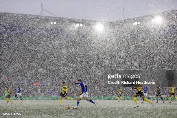 General view inside the stadium as snow falls with Timothy Castagne of Leicester City running with the ball during the Premier League match between...