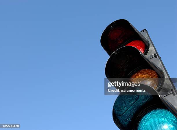 close-up of traffic lights against blue sky - traffic light stock pictures, royalty-free photos & images