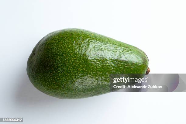 green ripe avocados isolated on a white background. vegetarian, vegan and raw food food and diet. the concept of vegetarianism, veganism and raw food. organic eco-farm products. a copy of the space. - avocado isolated imagens e fotografias de stock