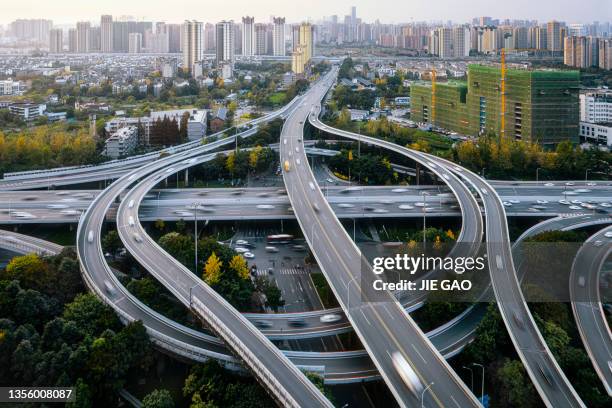 overpass and modern architecture photographed in chengdu at dusk - overpass stockfoto's en -beelden