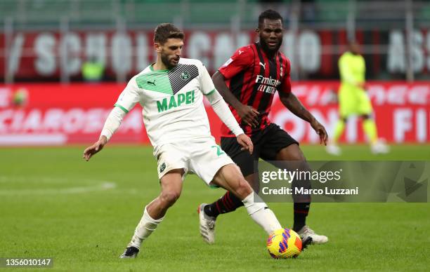 Domenico Berardi of US Sassuolo is challenged by Franck Kessie of AC Milan during the Serie A match between AC Milan and US Sassuolo at Stadio...