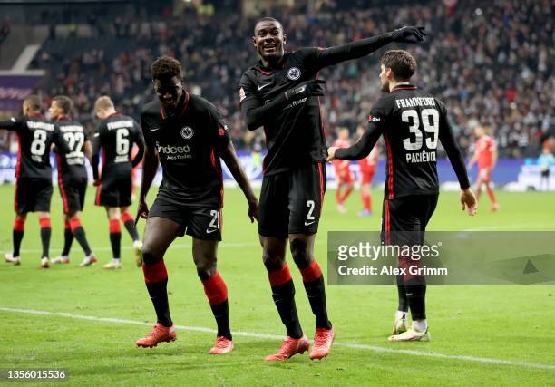 Obite Evan Ndicka of Eintracht Frankfurt celebrates his 2-1 goal with teammates Ragnar Ache and Goncalo Paciencia during the Bundesliga match between...