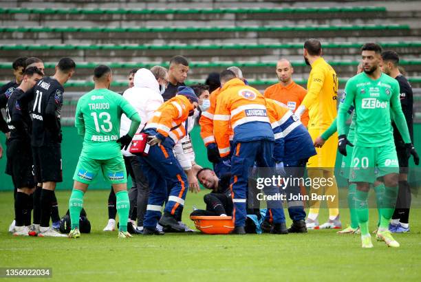 Injured on the ankle, Neymar Jr of PSG leaves the pitch on a stretcher while Kylian Mbappe of PSG looks on during the Ligue 1 Uber Eats match between...