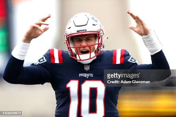 Mac Jones of the New England Patriots shouts during warm-up before the game against the Tennessee Titans at Gillette Stadium on November 28, 2021 in...