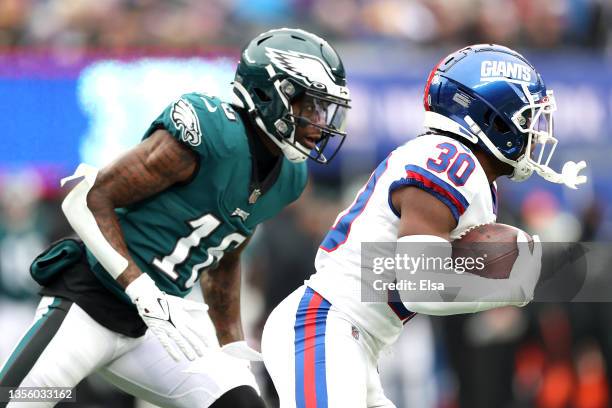 Quez Watkins of the Philadelphia Eagles pursues Darnay Holmes of the New York Giants after Holmes intercepted a pass intended for Watkins in the...