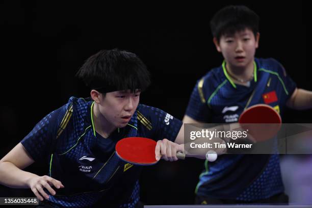 Wang Chuqin of China plays a shot against Lin Yun-Ju and Cheng I-Ching of Chinese Taipei during the mixed doubles semifinals match of the 2021 ITTF...