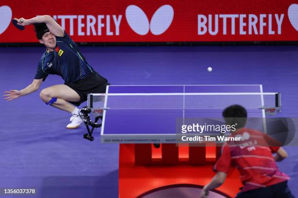 Wang Chuqin of China plays a shot against Lin Yun-Ju and Cheng I-Ching of Chinese Taipei during the mixed doubles semifinals match of the 2021 ITTF...