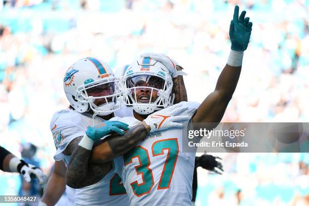 Myles Gaskin of the Miami Dolphins celebrates with teammates after scoring a touchdown during the second quarter against the Carolina Panthers at...