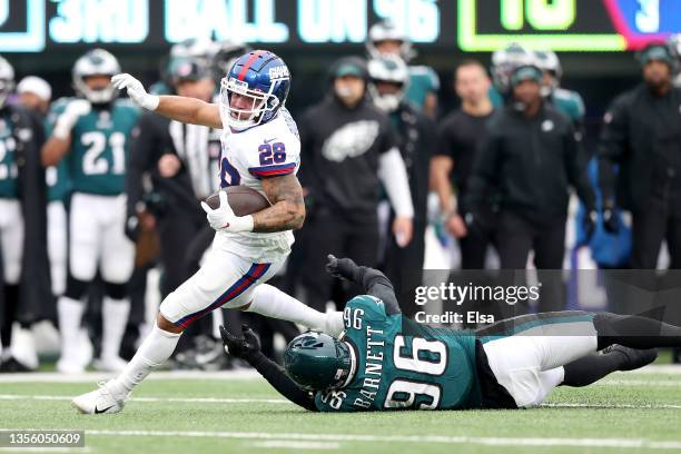 Devontae Booker of the New York Giants runs with the ball for a first down against Derek Barnett of the Philadelphia Eagles in the third quarter at...