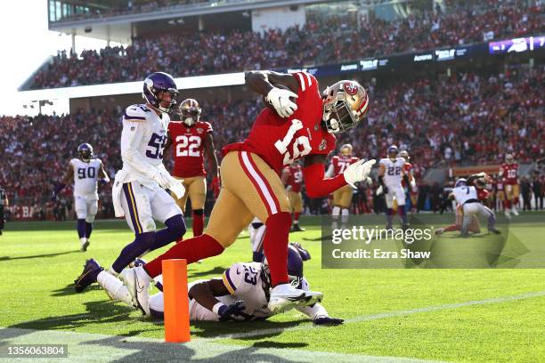 Deebo Samuel of the San Francisco 49ers rushes for a touchdown against Xavier Woods of the Minnesota Vikings in the first quarter at Levi's Stadium...