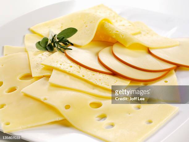 slices of swiss cheese - cheese stock pictures, royalty-free photos & images
