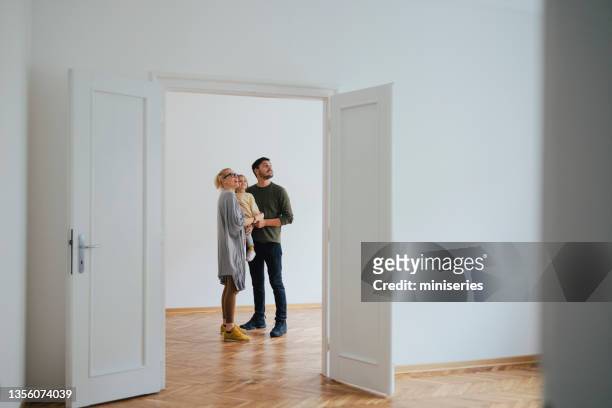 excited family moving in new home - family wide angle stock pictures, royalty-free photos & images