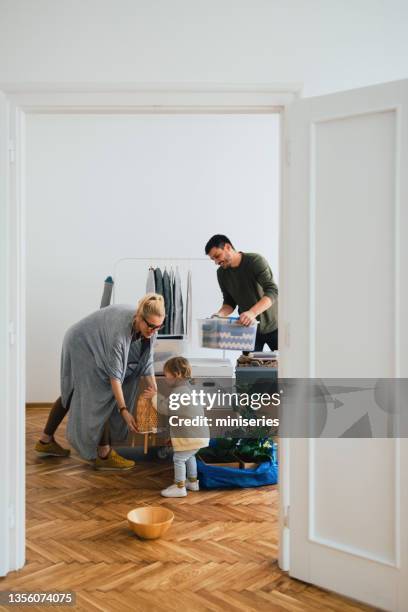 cheerful family moving in new home - possession stock pictures, royalty-free photos & images