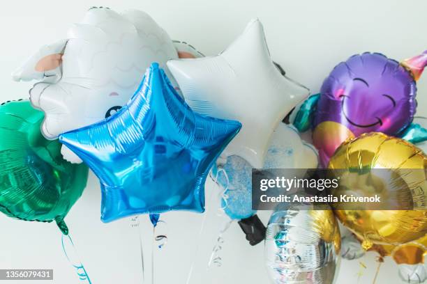 stylish metallic multicoloured balloons for birthday party on a white background. - birthday balloon stock pictures, royalty-free photos & images
