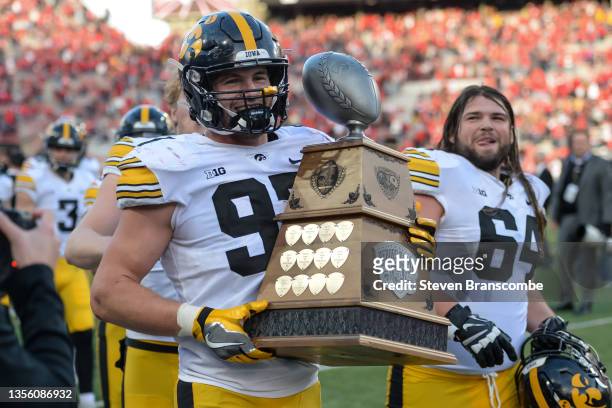Defensive lineman Zach VanValkenburg of the Iowa Hawkeyes holds the Heroes Game Trophy after the game against the Nebraska Cornhuskers at Memorial...