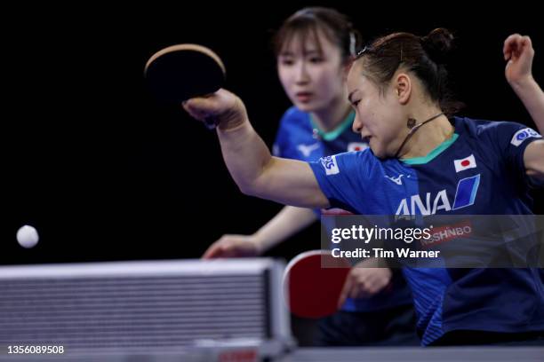Mima Ito of Japan plays a shot against Qian Tianyi and Chen Meng of China during the women's doubles semifinals match of the 2021 ITTF World Table...